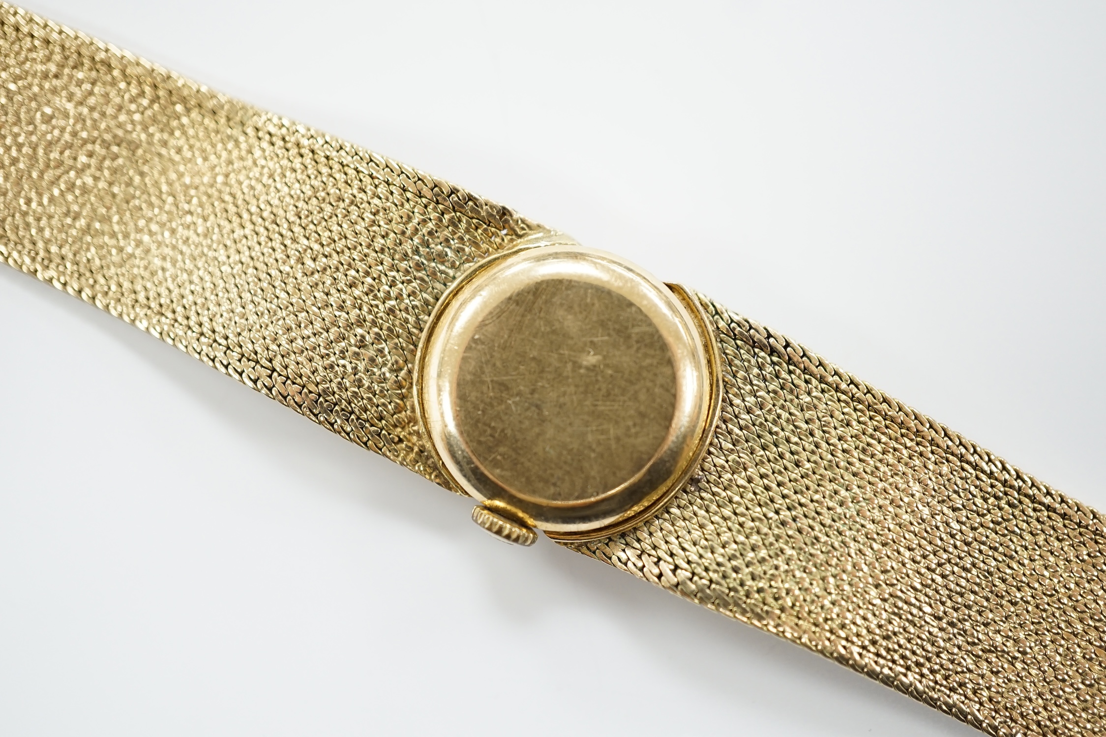 A lady's 9ct gold Tissot manual wind wrist watch, on a 9ct bracelet, 16cm